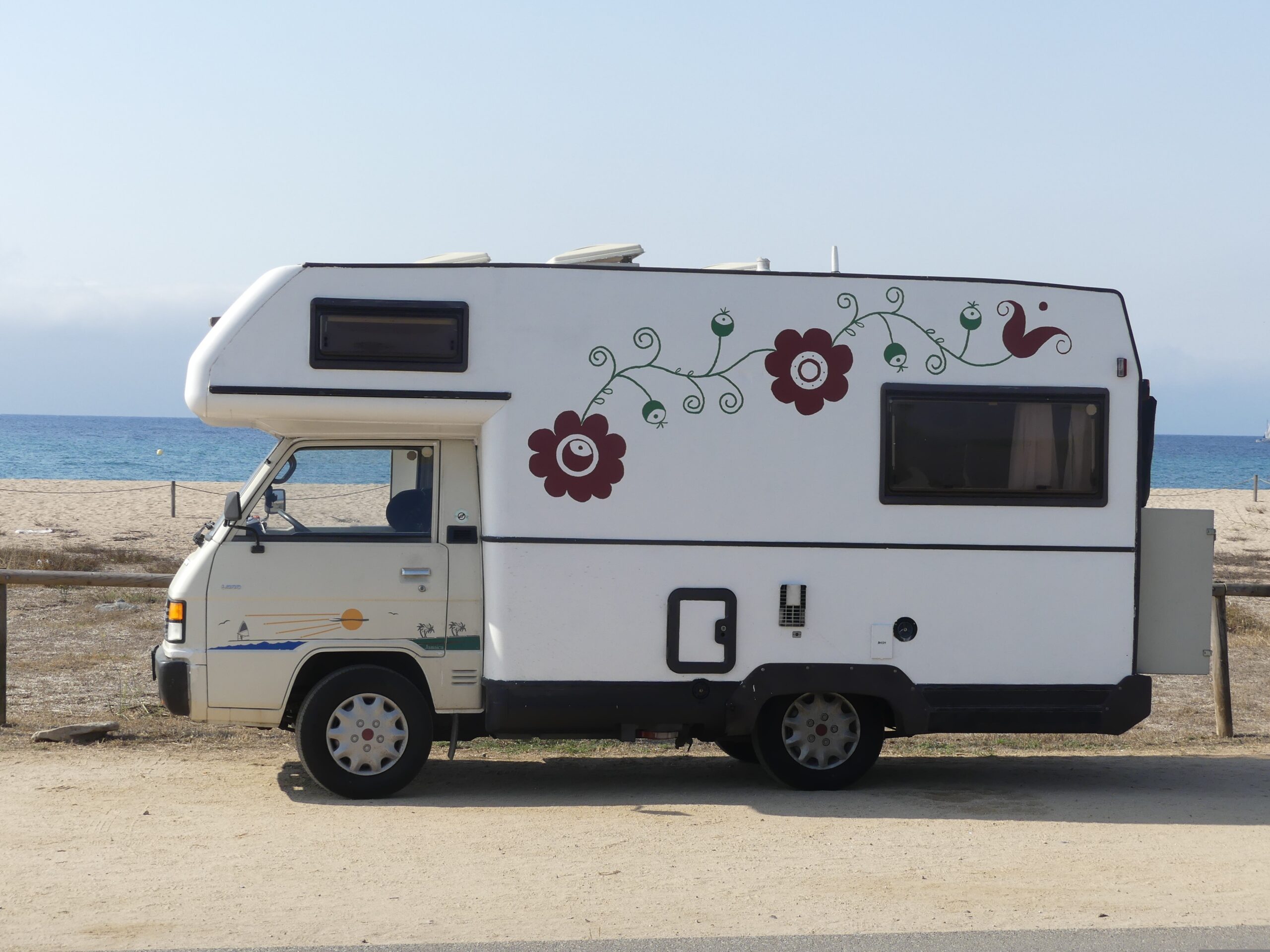 Travel trailer at campsite — RV rental fleet TPMS protects operators from liability and review damage caused by unfamiliar driver tyre incidents